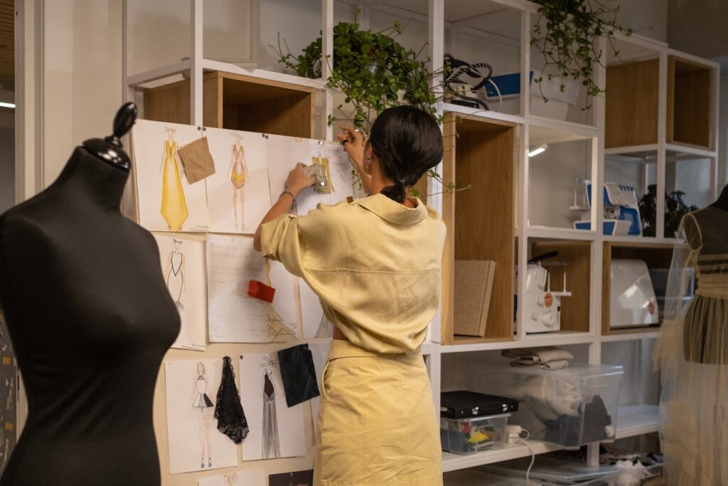 a female fashion designer creating dress designs and goal setting how she wants it to look