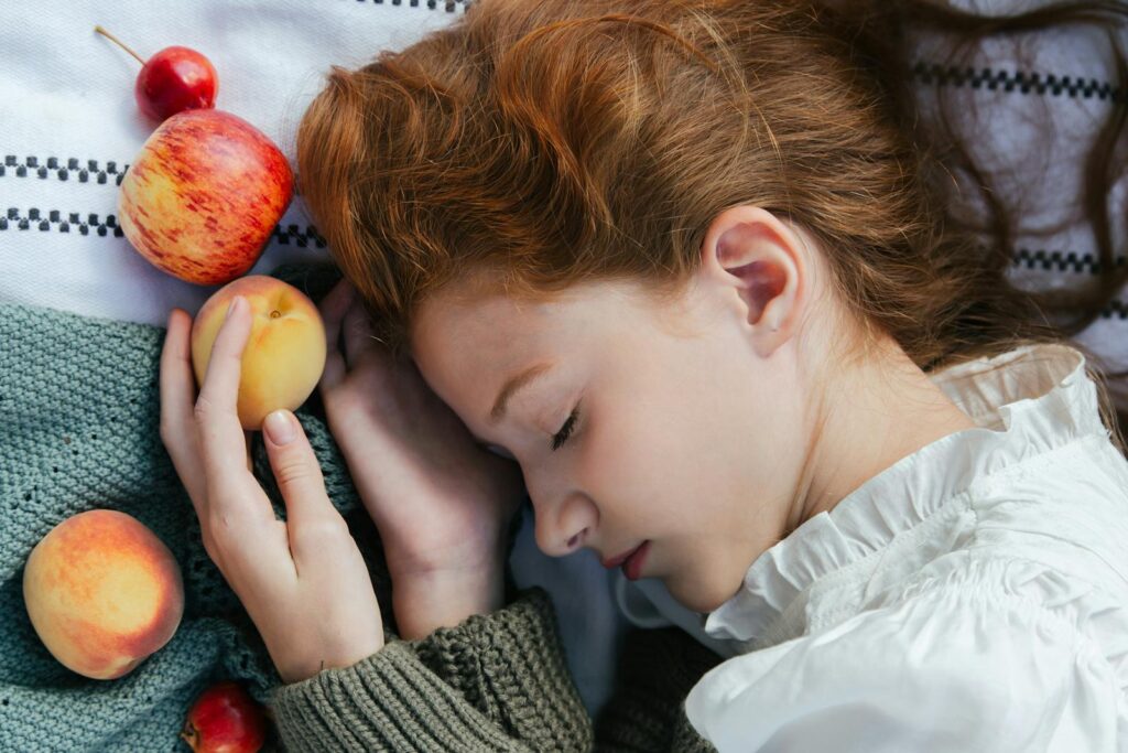 A serene image of a woman with closed eyes holding fruit shows how easy it is to manifest your dreams